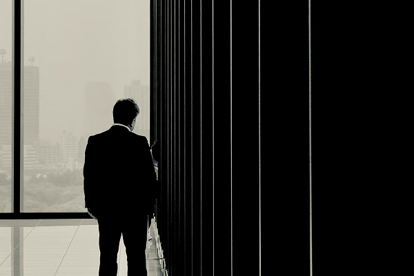 Businessman in modern office overlooking city