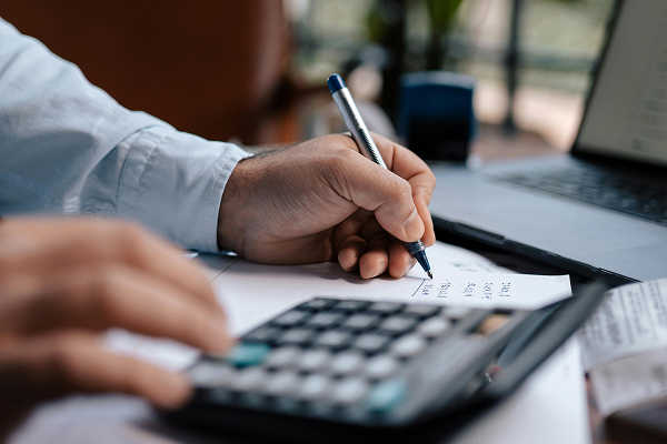 A Person Using a Calculator