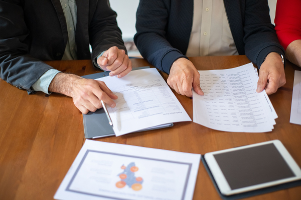 man hands on table showing contract papers